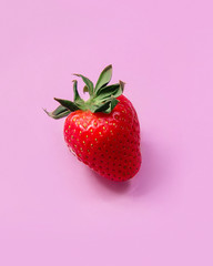 Strawberry on blank pastel pink background. Minimal idea food concept. Flat lay