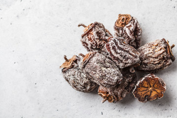 Dried sweet persimmon on a white background, copy space.