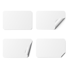 Set of white rectangle adhesive stickers with a folded edges, isolated on white background.