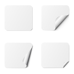 Set of white square adhesive stickers with a folded edges, isolated on white background.