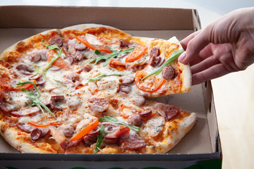  Delicious round pizza with vegetables and ham.