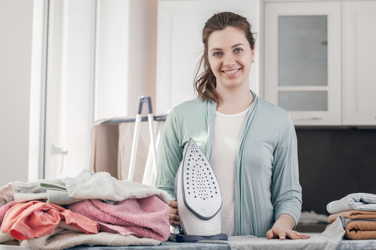 Household chores. Woman cleans and folds clean things.