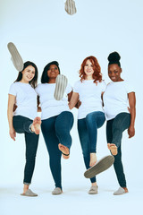 friendship, fashion, body positive, diverse female beauty concept - group of happy multicultural different size women in casual wear having fun in white studio.
