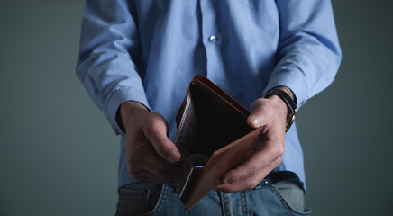 Bankruptcy - Business Person holding an empty wallet