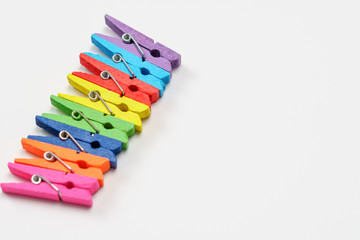 Colorful wooden clothespins on white background