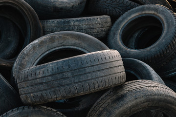 Used car tires close up. Wall of old car tires background