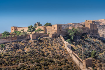 Fototapeta na wymiar Almeria medieval castle panorama with blue sky from the air in Andalusia Spain former Arab stronghold