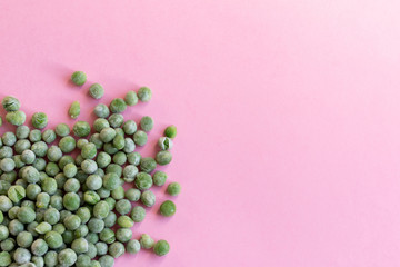 Frozen peas on pink background