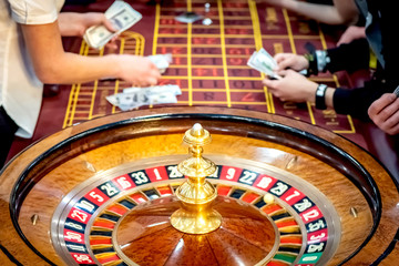 The croupier pays the winnings. Roulette. Gambling People make bets in casinos. A table with a tape measure. Lose money