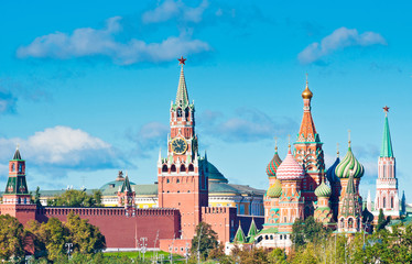 Obraz premium Spasskaya Tower of Moscow Kremlin and Cathedral of Vasily the Blessed (Saint Basil's Cathedral) in sunny day. Red Square. Moscow. Russia