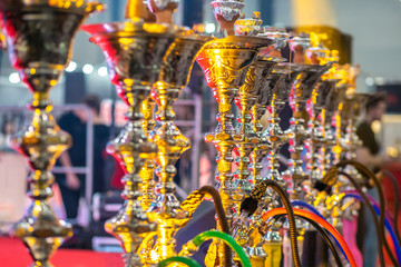 A lot of hookahs. Hookahs shimmer in different colors. Bar.