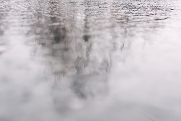 Vile wet weather on the streets of the city. Wet asphalt from melting snow.