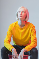 young gorgeous woman thinking about something while sitting on the chair, close up photo. albino...