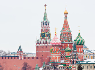 Fototapeta premium Spasskaya Tower of Moscow Kremlin and the Cathedral of Vasily the Blessed (Saint Basil's Cathedral) on Red Square. Winter day. Moscow. Russia