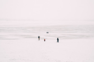 People on the frozen river. Ice walk