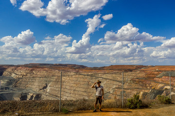young man at the lookout of the australian gold mine - super pit in Kalgoorlie, Western Australia