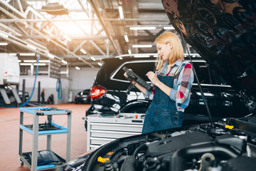 attractive famale mechanic enjoying her work, close up photo. copy space