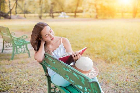 Young woman relaxing in the natural park. Studen on vacation and summer holiday in the garden.