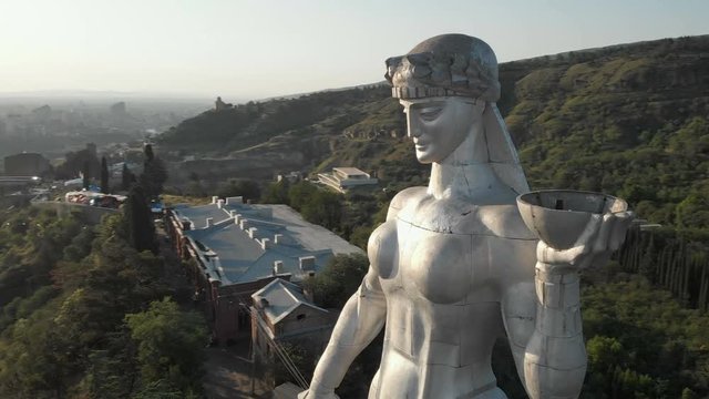 Quadcopter fly around of Kartlis Deda, Mother of Georgia statue in capital of Georgia, Tbilisi. From bottom to top view. Slow motion. Aerial video