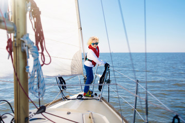 Fototapeta premium Kids sail on yacht in sea. Child sailing on boat.