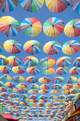 Obraz premium Colorful umbrellas background. Colorful umbrellas in the sky. Street decoration
