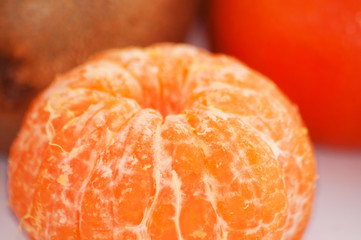 Delicious juicy peeled mandarin close-up macro