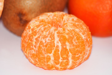 Delicious juicy peeled mandarin close-up macro