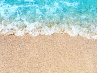 Fototapeta na wymiar Sea sand beach, blue blurred wave. Summer vacation concept. Copy space