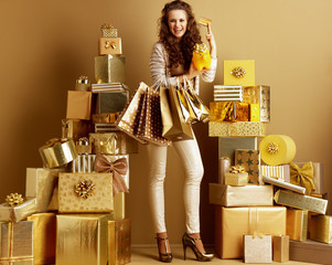 fashion-monger with shopping bags and yellow piggy bank with gol © Alliance