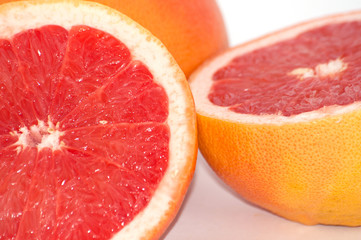Obraz na płótnie Canvas Slices of grapefruit macro closeup on white background