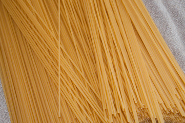 Raw spaghetti on a gray background