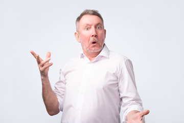 Fototapeta premium Astonished man trying to argue with his wife.
