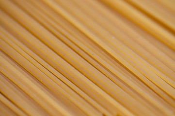 Raw spaghetti on a gray background close-up top view side macro