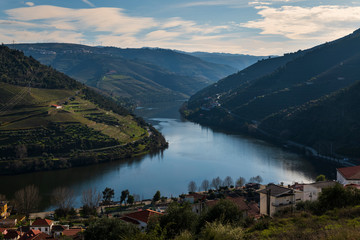 View of the Pinhao village with terraced vineyards and the Douro River, in Portugal; Concept for travel in Portugal and most beautiful places in Portugal