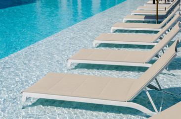 Swimming pool with chaise loungers
