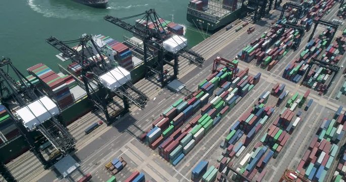 Cargo container ship is loaded / unloaded at Hong Kong container terminal top view