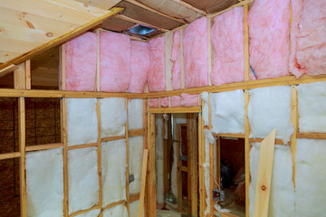 Wooden frame for future walls insulated with rock wool and fiberglass insulation - obrazy, fototapety, plakaty