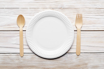 Wooden single use kitchenware on white table. Top view, space for text.