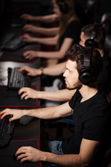Obraz na płótnie Canvas Leading esport team mousesports training together in a e-sport club getting prepared to online Cyber Games Tournament and have all chances to beat their opponents in upcoming contest.