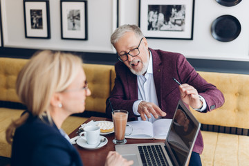 awesome bearded man and woman in glasses taking part in online conference, workshop, seminar. close up photo