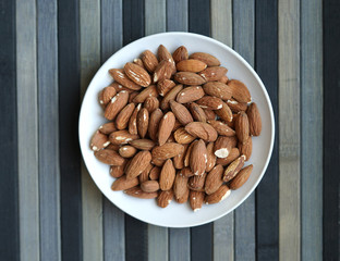 Healthy food  for background image close up almond nuts. Texture Nuts on the cup plate