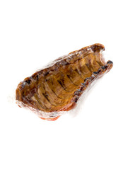 Smoked ribs on a white background. Smoked ribs in a vacuum pack on a white background.
