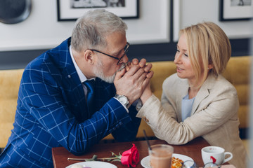 loving man kissing his woman's hands and showing his feeling and love. man thanking his wife for happy life. close up photo. ideal relationship between woman and man. smart man asking forgiveness