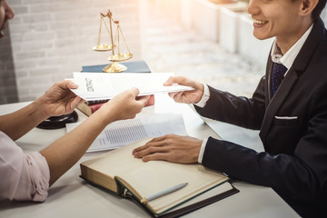 Male lawyer explain a contract agreement to client for law .Law and Legal services concept.