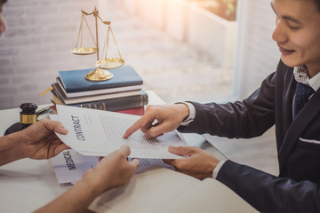 Male lawyer explain a contract agreement to client for law .Law and Legal services concept.