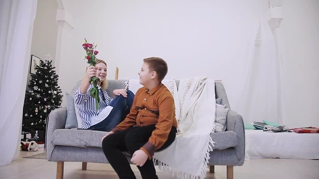 Boy gives flowers to girl
