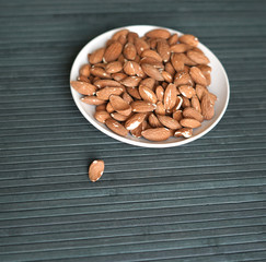 Healthy food  for background image close up almond nuts. Texture Nuts on the cup plate