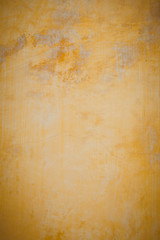 Old plaster walls painted gold. Texture of the wall.