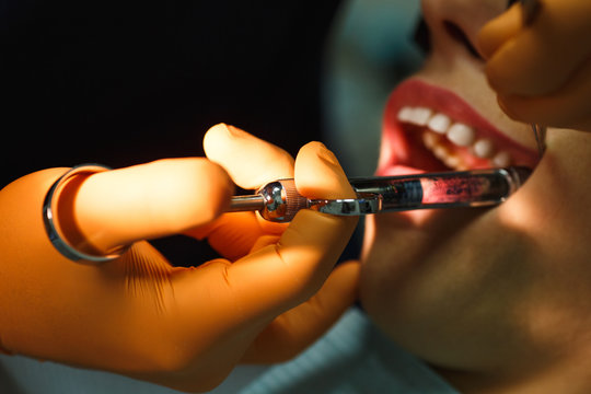 Close up of doctor holding syringe with dental anesthetic. Medicine, dentist, and health care concept
