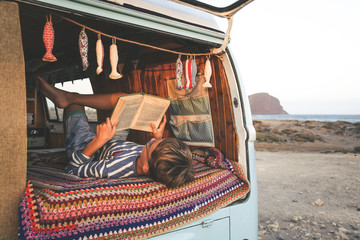 Young boy on retro mini van transport read a book Life inspiration concept with family  minivan...